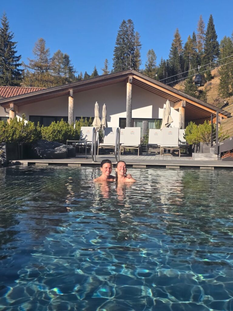 Soaking in alpine sunlight with a dear friend in a warm mountain pool in the Dolomites.